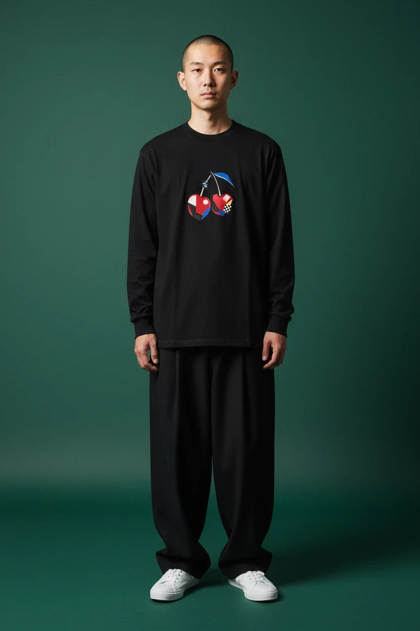 ODD COMMON black long-sleeve t-shirt with a geometric cherry graphic featuring pixelated noise and checkered patterns.