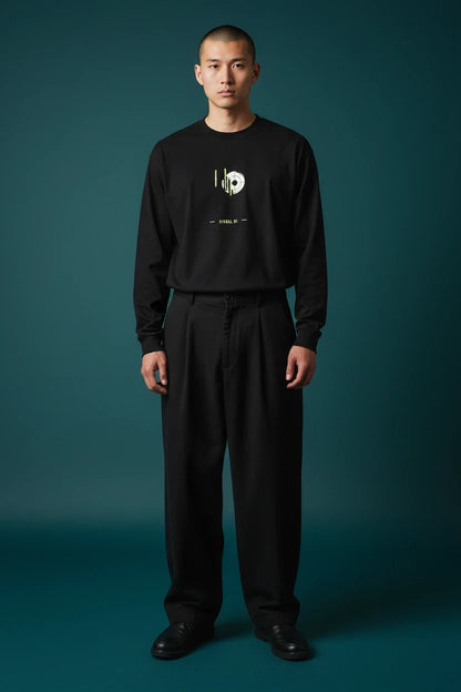 ODD COMMON black long-sleeve graphic t-shirt with lime green signal wave print worn by a man against a dark background