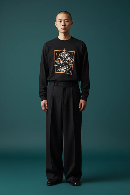 ODD COMMON black long-sleeve graphic t-shirt featuring a surreal three-eye illustration on a male model