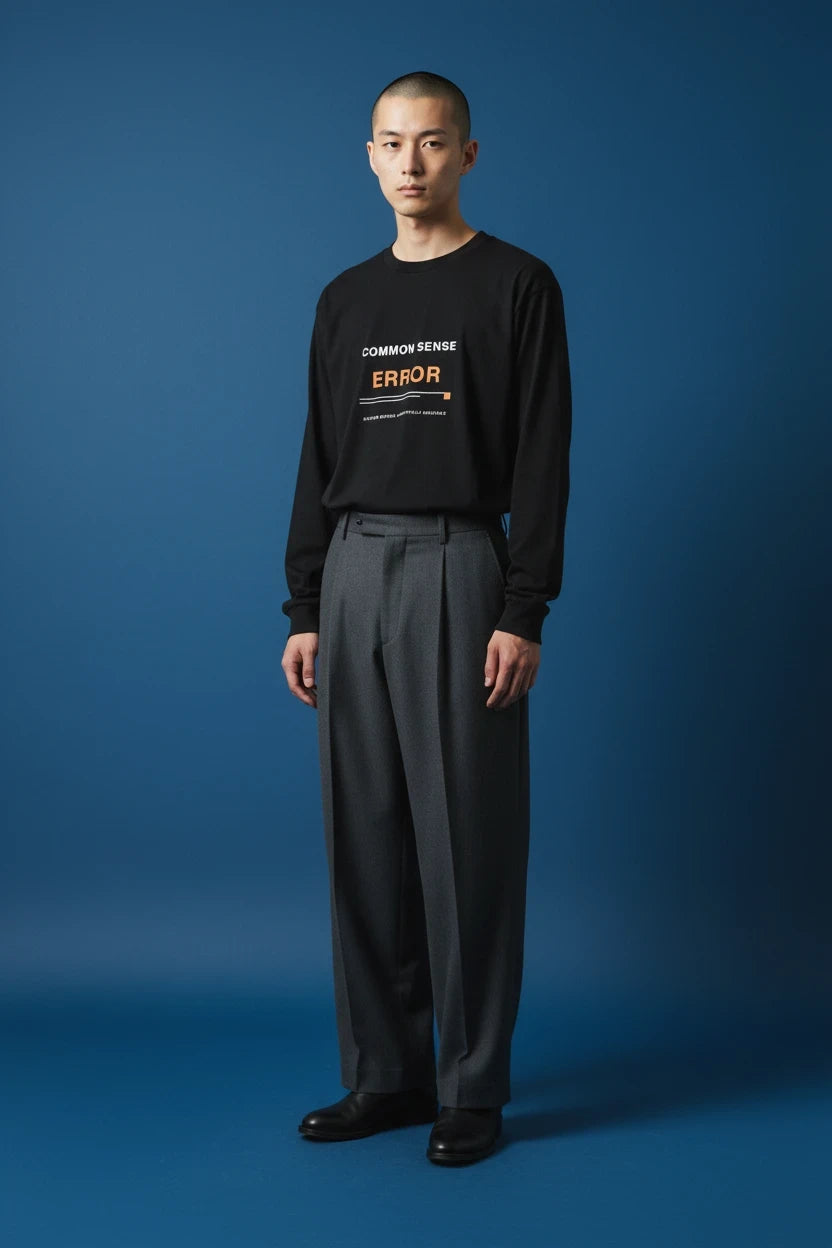ODD COMMON black long-sleeve t-shirt with white COMMON SENSE and red ERROR graphic text on a model