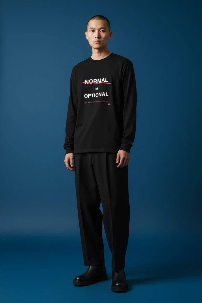 ODD COMMON black long-sleeve t-shirt with white Normal Is Optional typography and a red strike-through line.