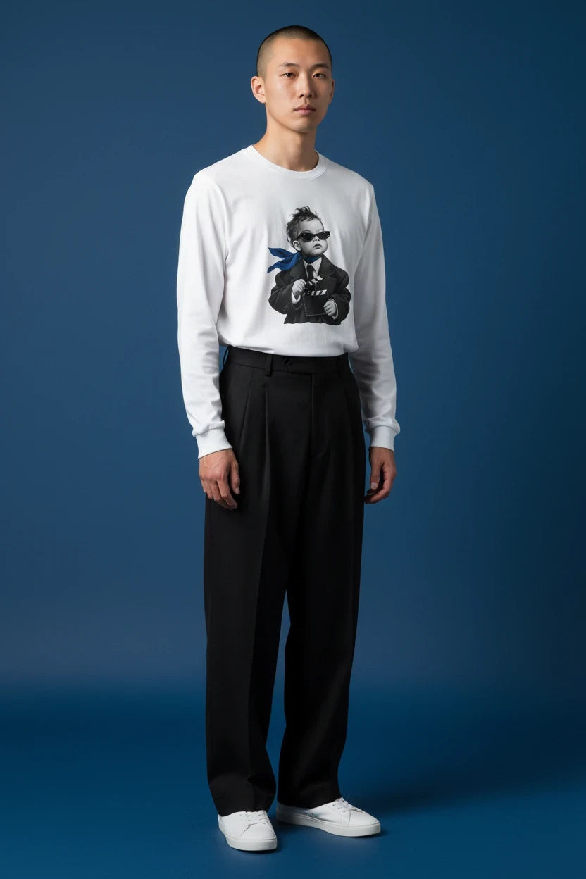 ODD COMMON white long-sleeve graphic t-shirt featuring a stylish director baby print, worn by a male model.