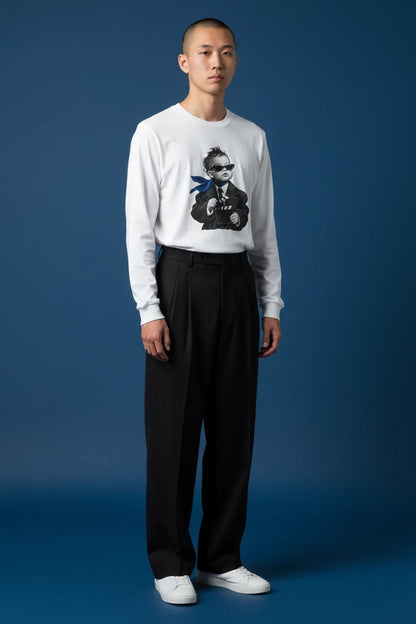 ODD COMMON white long-sleeve graphic t-shirt featuring a stylish director baby print, worn by a male model.