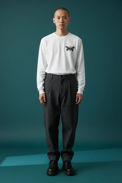 ODD COMMON white long-sleeve t-shirt with a detailed butterfly and eye graphic on the chest, worn by a male model.